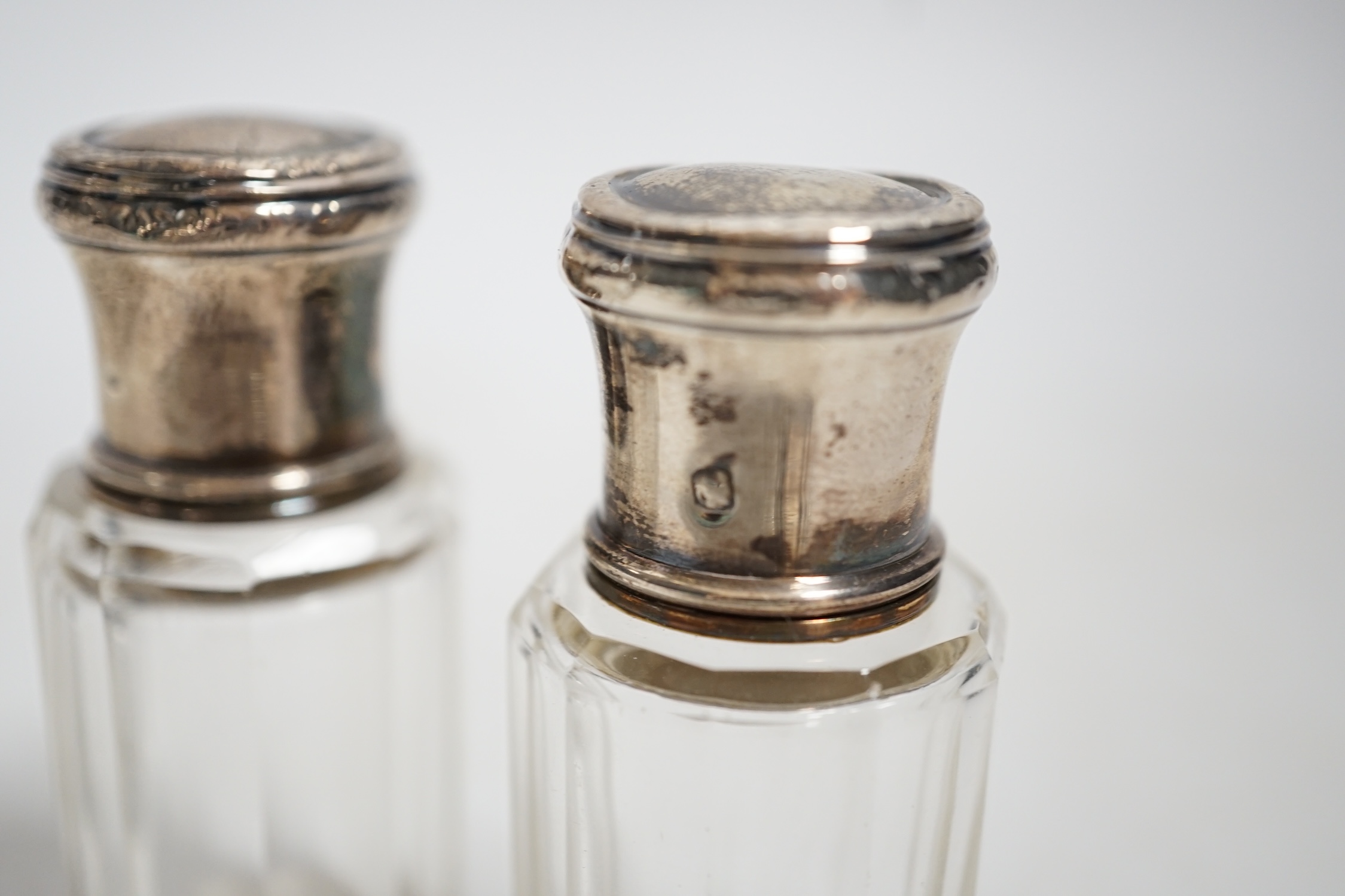 A Victorian silver mounted glass claret jug, W & G Sissons, Sheffield, 1879, 27.4cm, together with three mounted glass bottles, two with French white metal mounts.